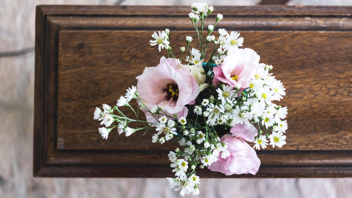 Pink flowers on a casket